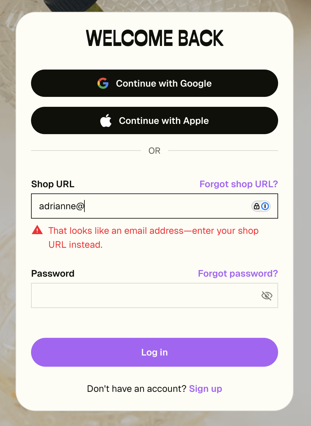 Sign-in screen showing the email-detection error message when an email address is typed into the Shop URL field
